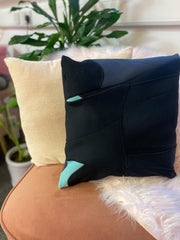 A sustainable eco cushion made from a broken wetsuit that was going to landfill.